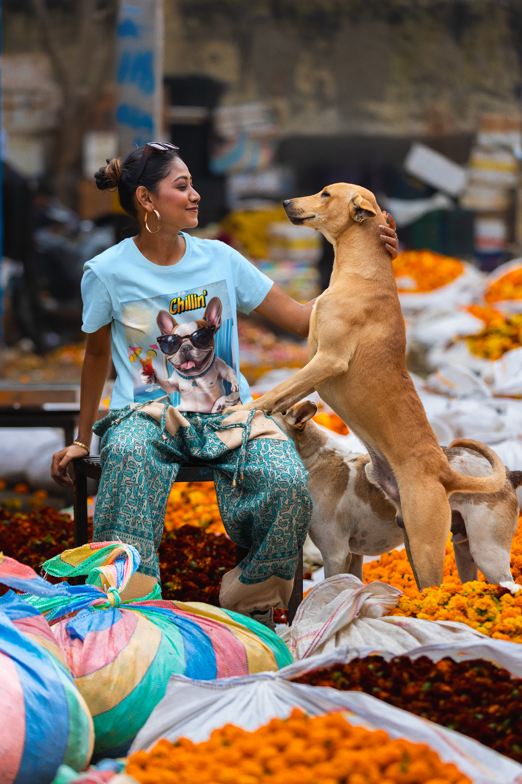 files/scott-international-t-shirt-mockup-of-a-smiling-woman-petting-a-dog-in-a-street-market-m37569.png